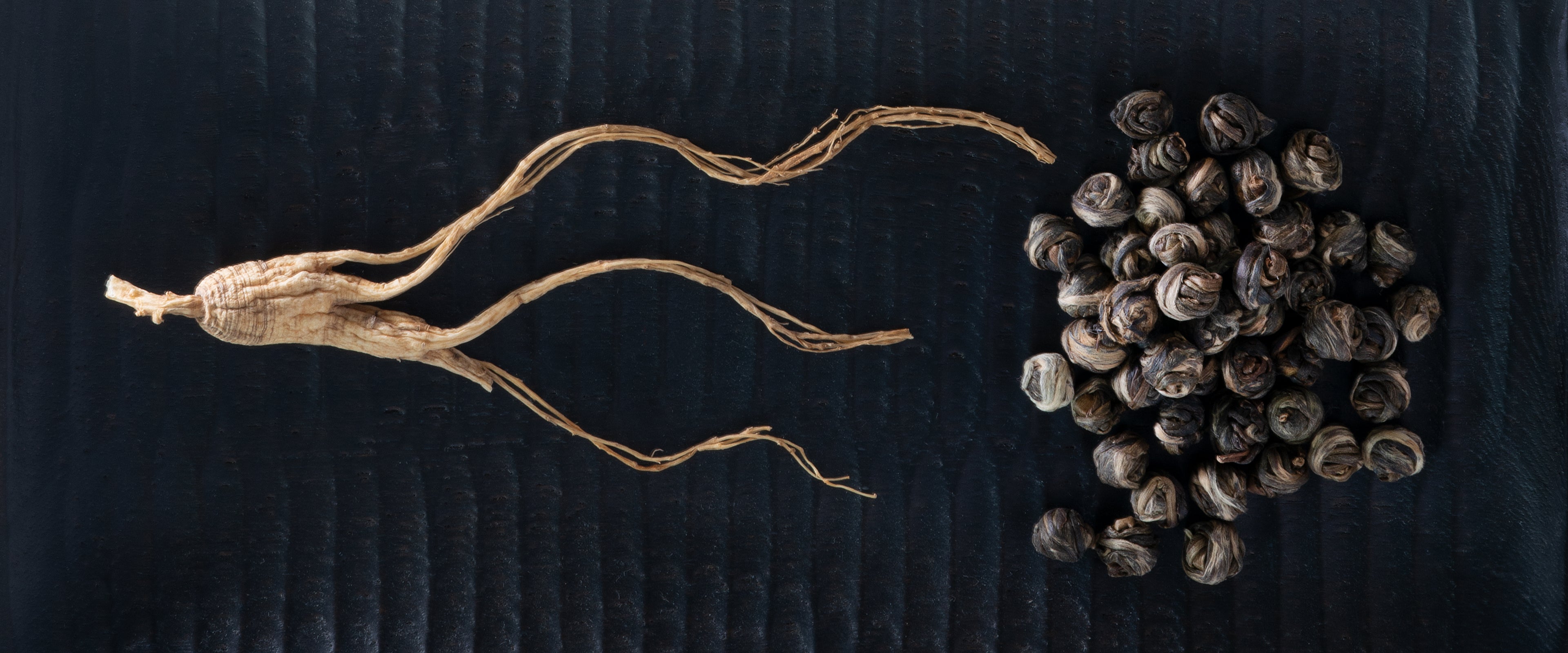 ginseng and green tea on black background